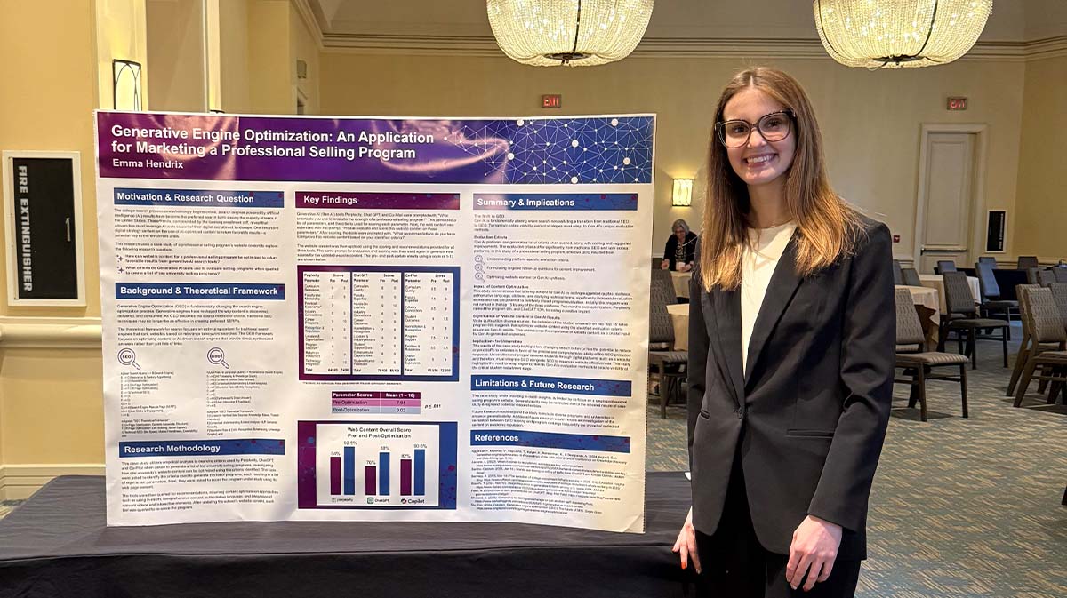 A woman stands beside her research poster titled "Generative Engine Optimization: An Application for Marketing Professional Selling Program."