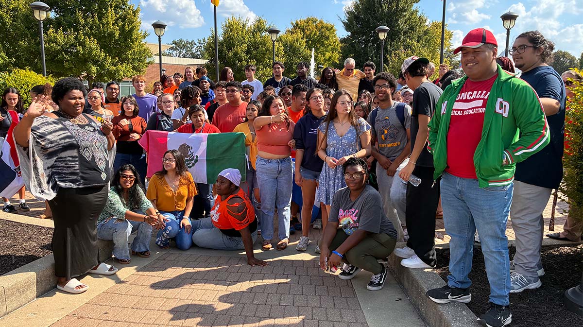 Hispanic students gathered around the fountain