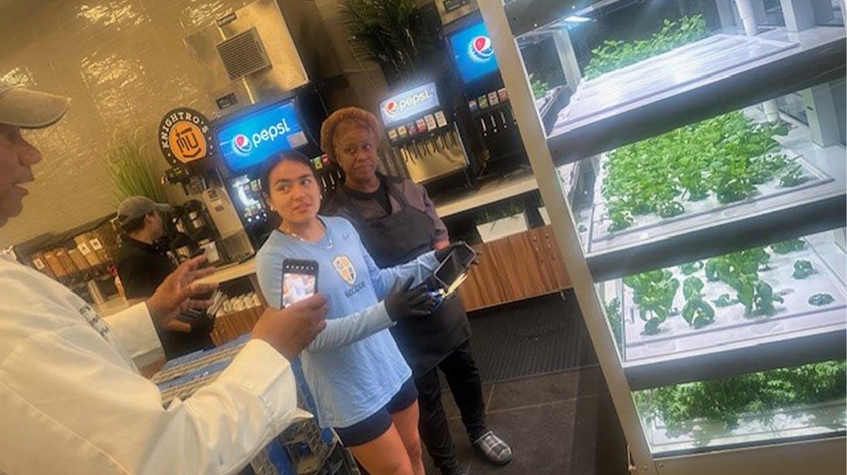 Student and dining working discussing hydroponic system