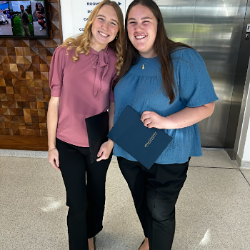 two students in business professional clothing