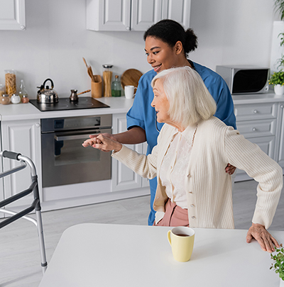 Healthcare worker in kitchen with elder