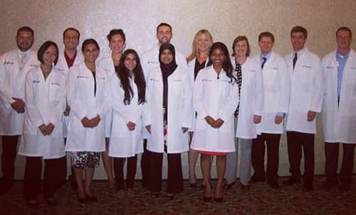Group photo of Dr. Solik in White Coat