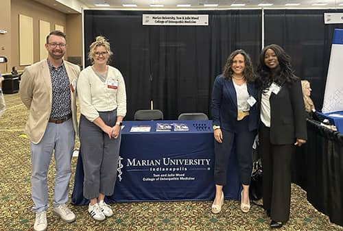 Thuwebat Adebayo, OMS-2, with MU-WCOM Admissions and Deans Team at a conference