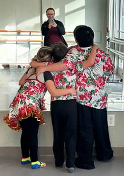 the back of three students getting photo taken