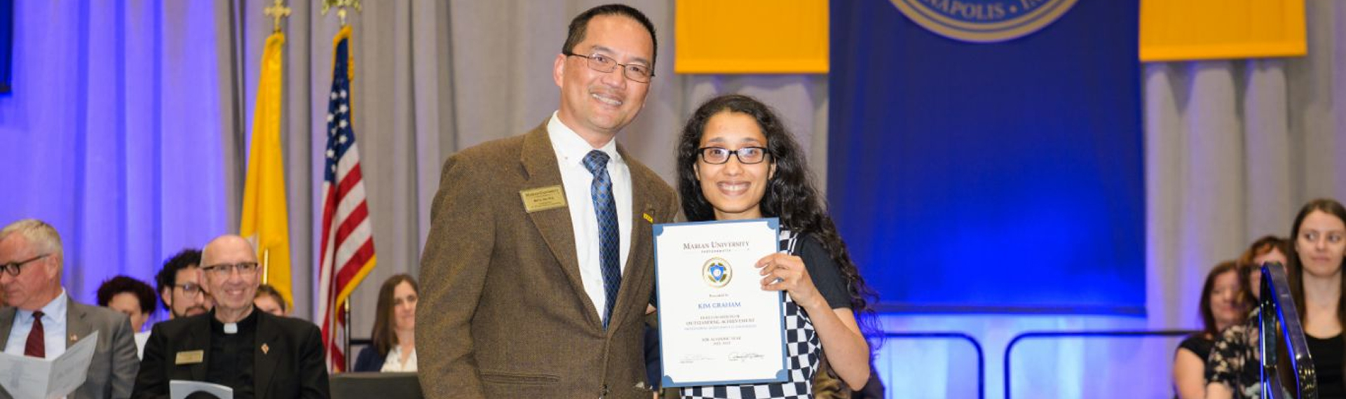 Student holding scholarship award
