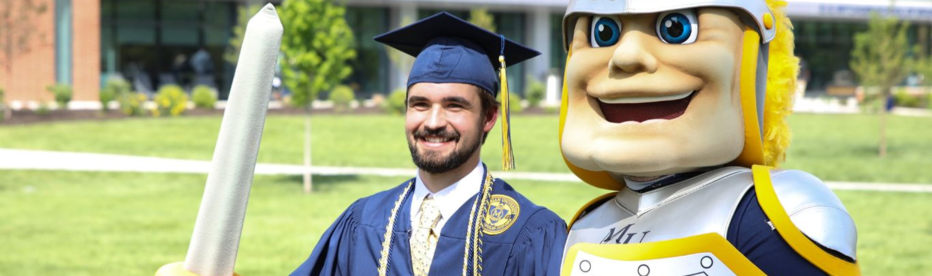 Student taking picture with school mascot