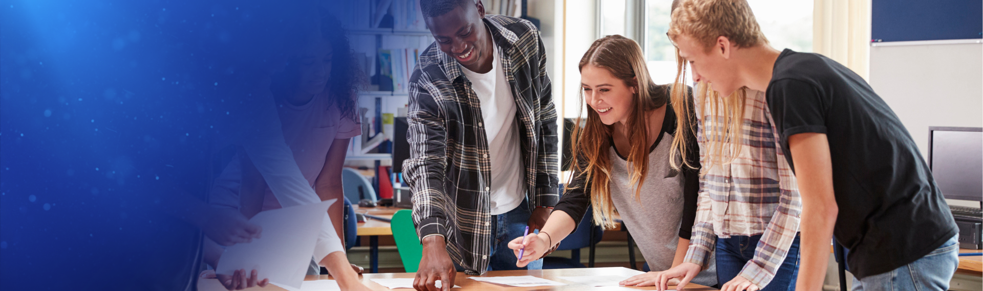 Two students walk with their backpacks and school supplies on campus. 