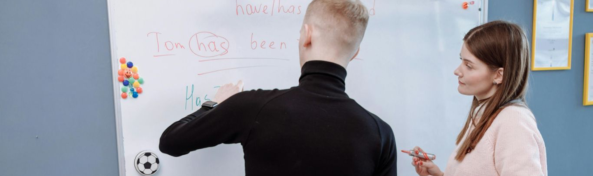 English professor with student at whiteboard