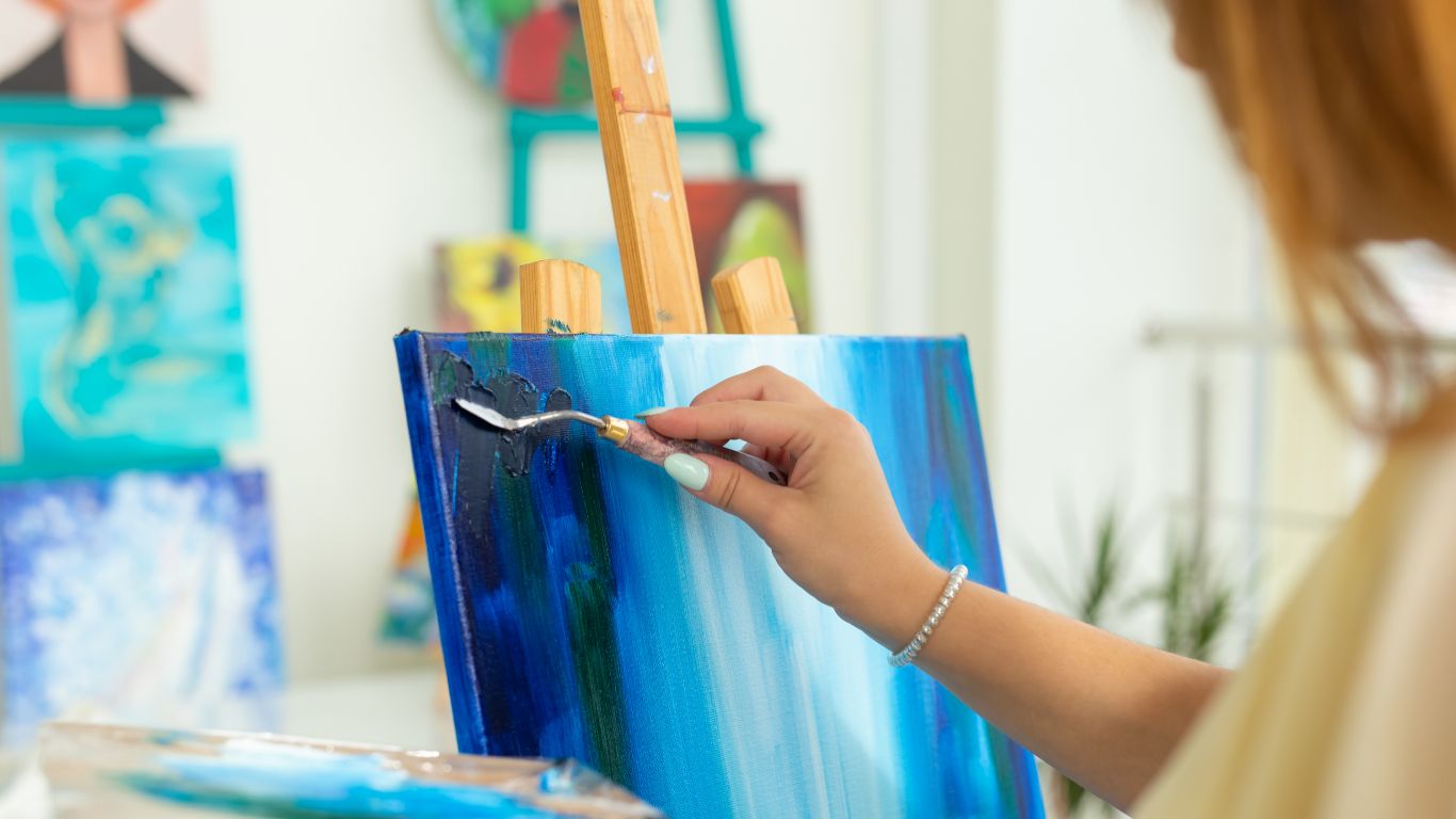 Student painting on canvas