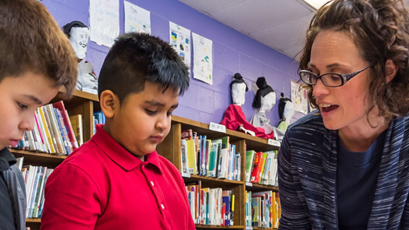 Professor talking to children in classroom