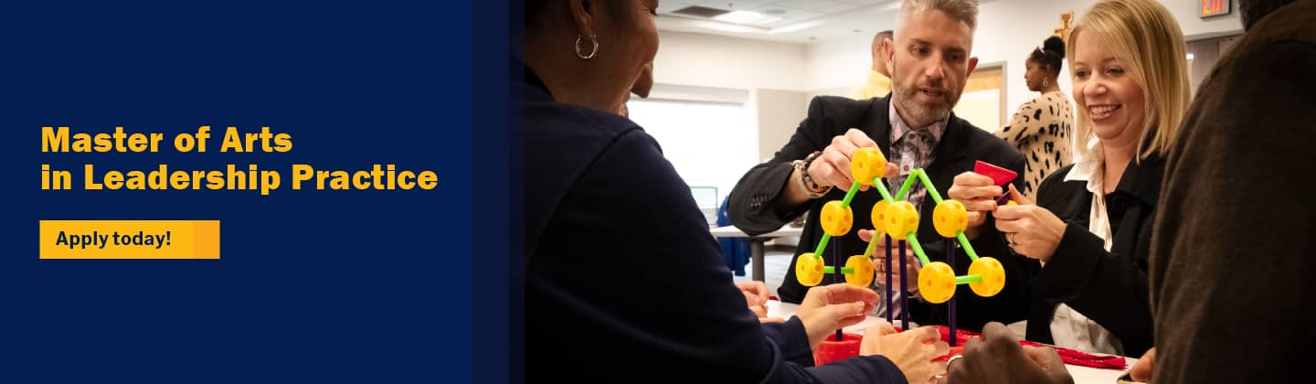 Adults in a workshop solving a puzzle