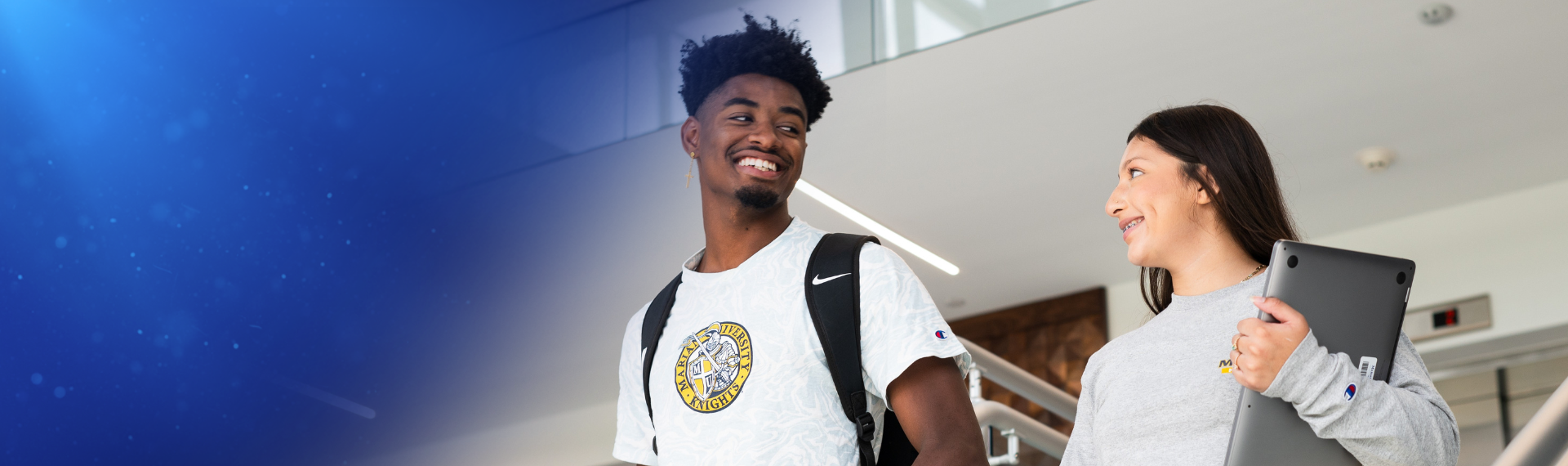 Business students, one carrying laptop