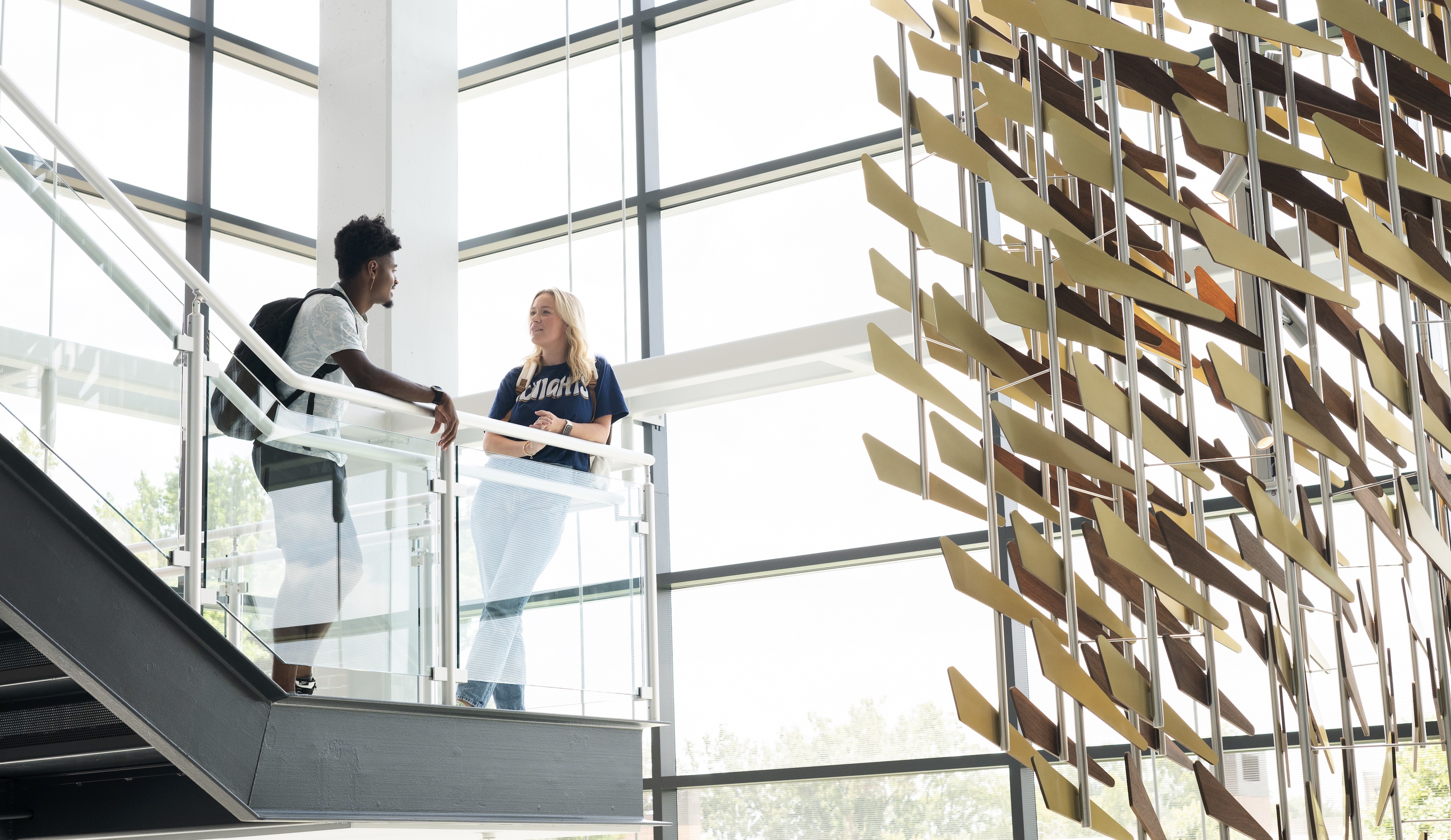 Students talking on a staircase in the engineering building