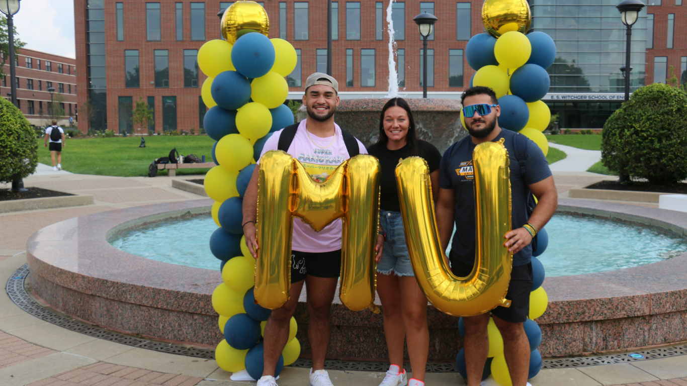Students posing with balloons
