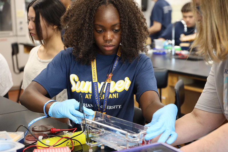 Marian summer camp participant working on a hands-on project