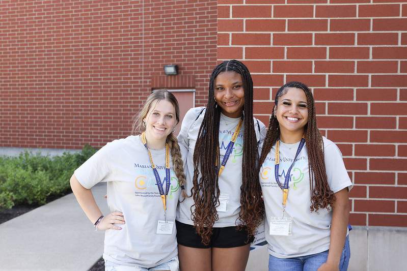 Two program participants posing for a photo with arms around each other