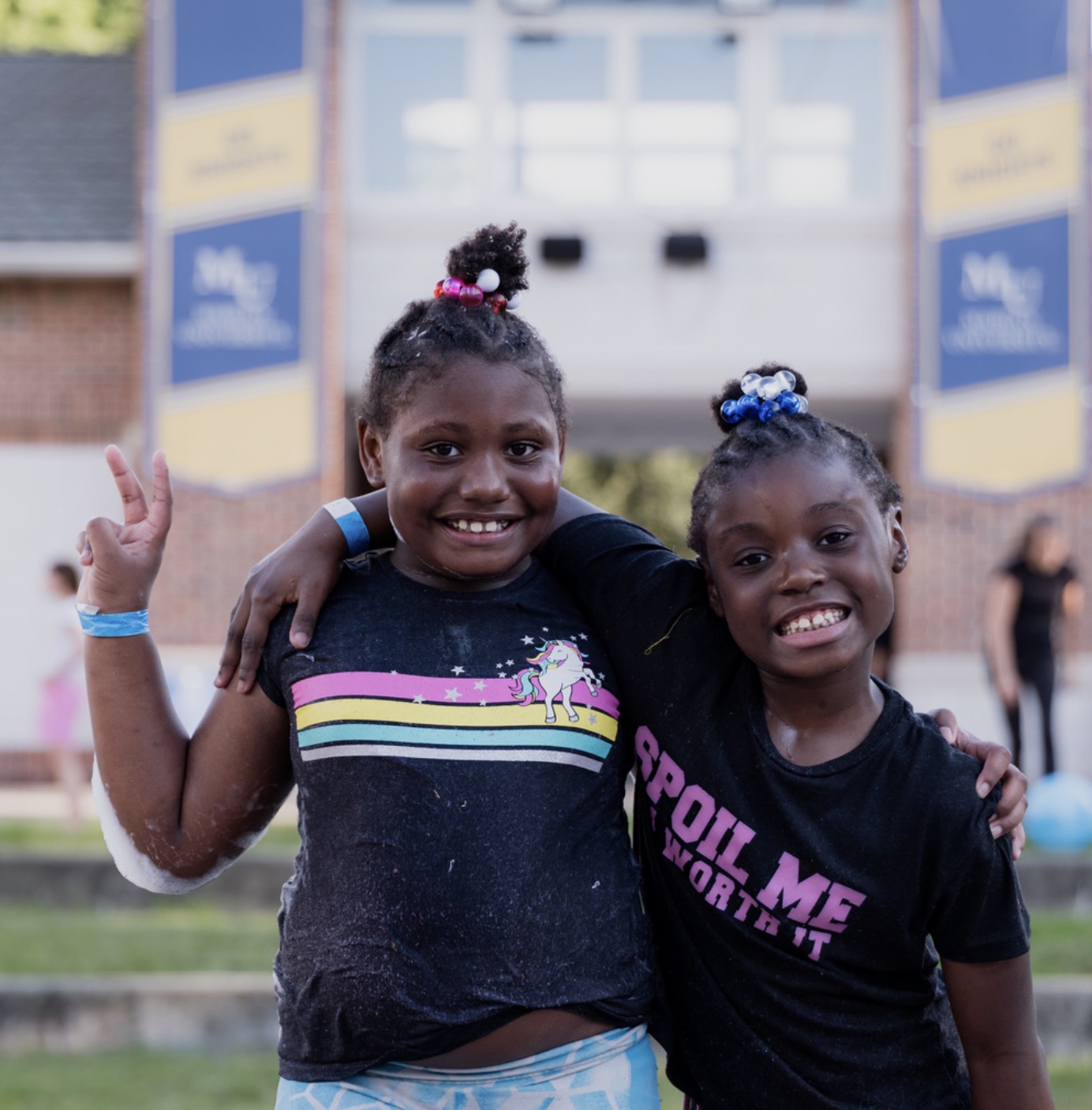 Two program participants posing for a photo with arms around each other