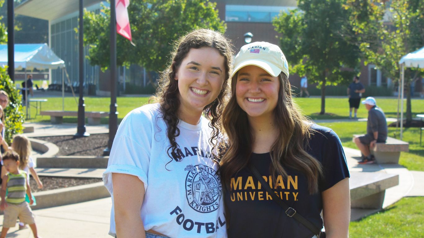 Students posing for a photo outside on campus