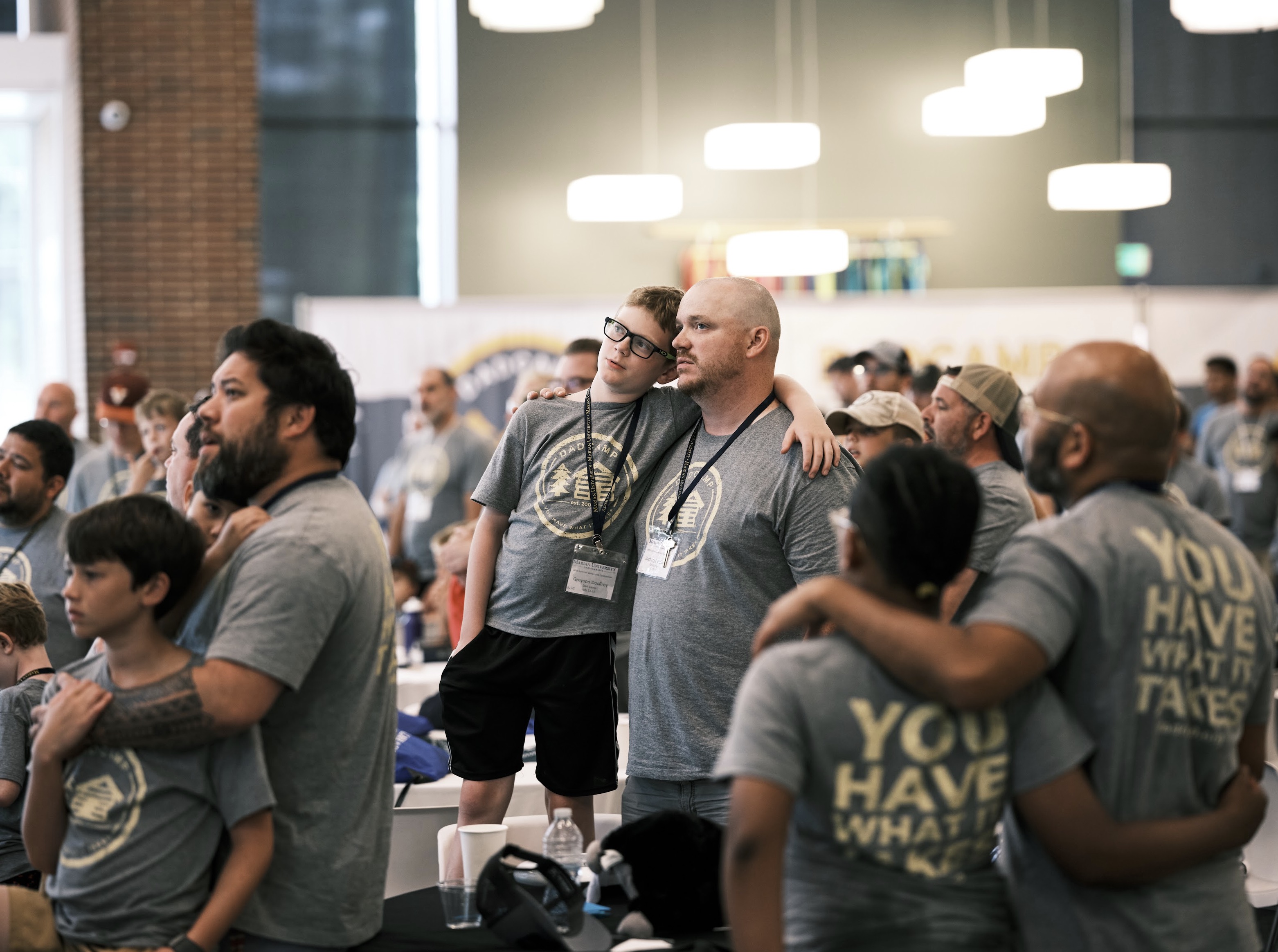 A group of fathers and sons listening to a program