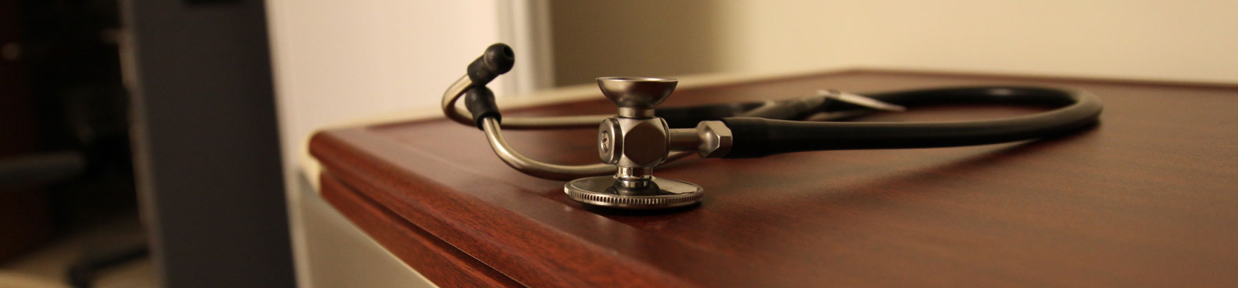 stethoscope laying on doctor's table