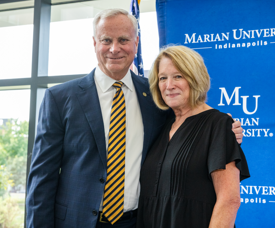 Dan and Beth Elsener smiling together at a Marian University event.