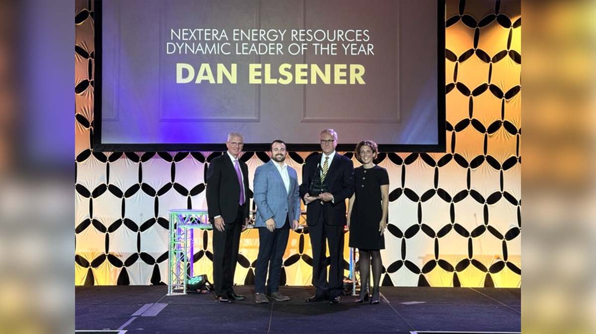 Nextera Energy Resources Dynamic Leader of the Year award presentation featuring Dan Elsener alongside three attendees on stage.