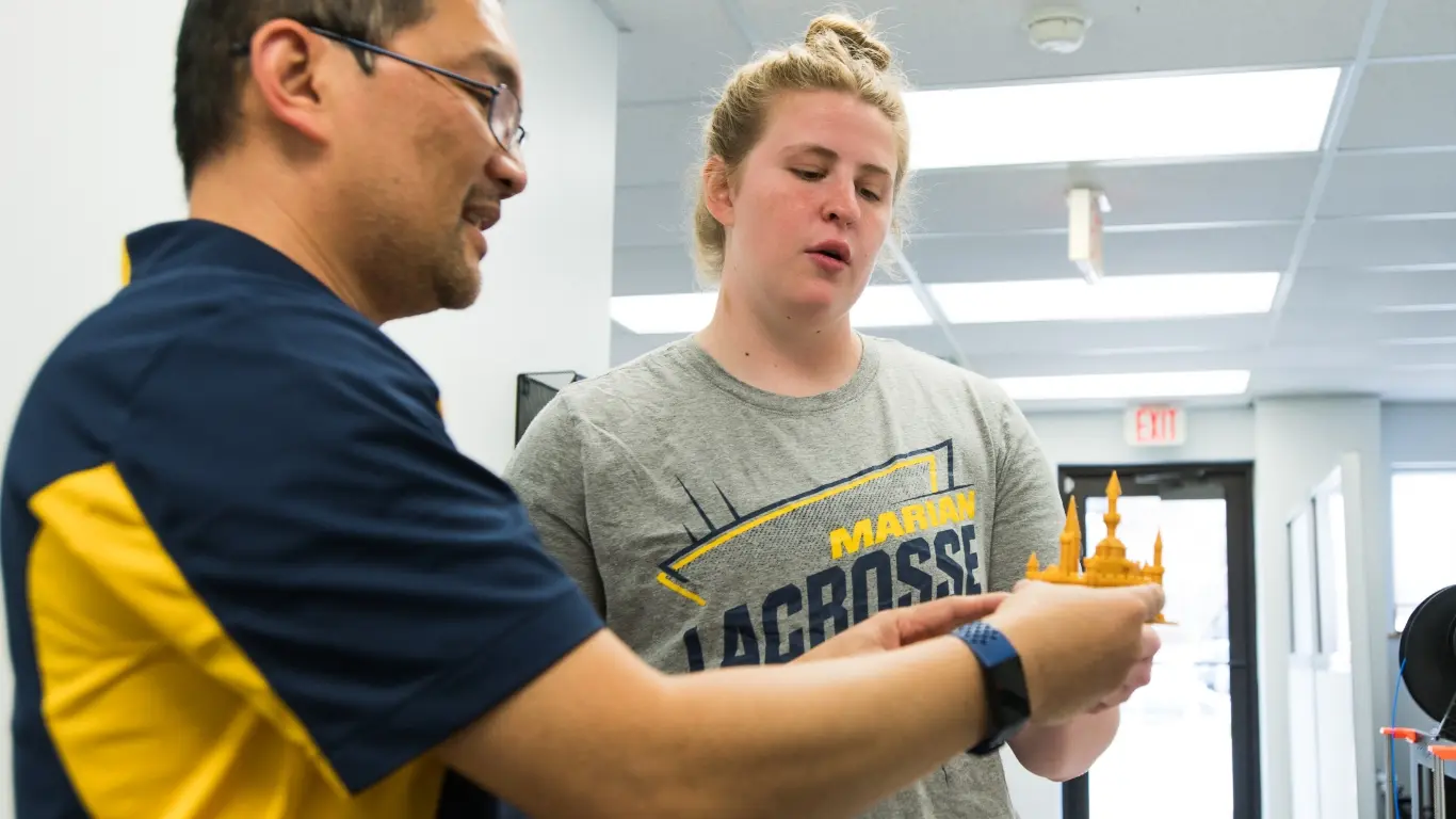 Chief Academic Officer with a Marian student